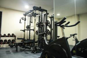 a gym with two exercise bikes and a mirror at Nevada Ketapang Hotel in Ketapang