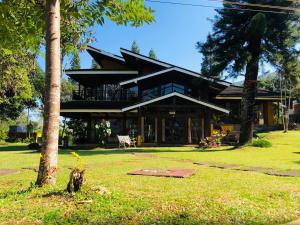 a building with a tree in front of it at Alfa Resort Hotel and Conference in Puncak