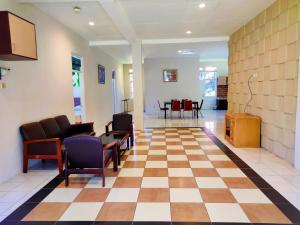a lobby with chairs and a checkerboard floor at Alfa Resort Hotel and Conference in Puncak