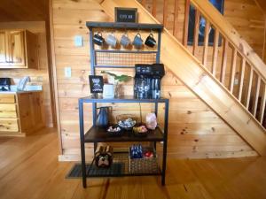 a room with a staircase and a shelf with pots and pans at MTN Cabin Sleeps 10 - 5 Mins To Fishing & Camping in Ellijay