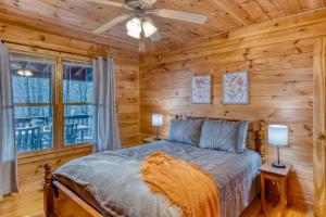 a bedroom with a bed in a log cabin at MTN Cabin Sleeps 10 - 5 Mins To Fishing & Camping in Ellijay