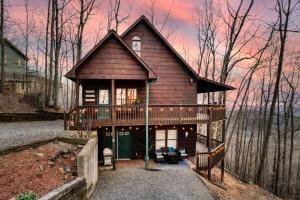 a house in the woods with a deck at MTN Cabin Sleeps 10 - 5 Mins To Fishing & Camping in Ellijay