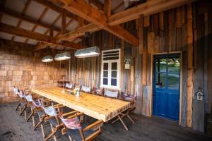 a dining room with a wooden table and chairs at First Class Backpackers Inn DAISEN - FBI DAISEN in Daisen