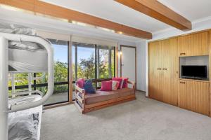 a bedroom with a bunk bed and a large window at Retro Retreat in Lorne