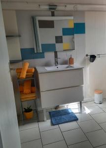 un bagno con lavandino e specchio di Spacieux cocon a Goyave