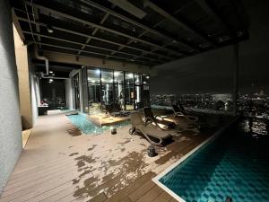 a gym with a view of the city at night at EkoCheras Residences by White Forest Suites in Kuala Lumpur
