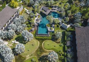 an overhead view of a mansion with a pool and trees at The Slate, Phuket in Nai Yang Beach