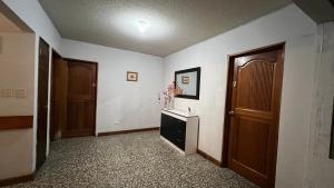 an empty hallway with two doors and a table at CASA AZALEA in Guatemala