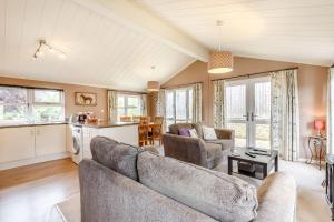 uma sala de estar com um sofá e uma mesa em Lavender Lodge em Sherborne