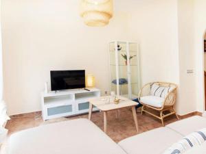 uma sala de estar com uma televisão e uma mesa em Apartamento "SA VIEIRA" BLANES COSTA BRAVA em Blanes