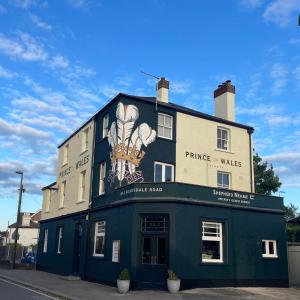 a building with a painting on the side of it at The Prince of Wales in Reigate