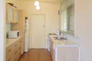 a kitchen with a sink and a microwave at Riverview in Anglesea