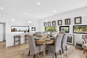 a dining room with a table and chairs at Oceania 11 in Lorne +13 photos