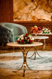 a table with a plate of fruit on top of it at Regal Inn Badamdar Hotel in Baku