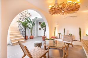 a living room with a table and chairs and a staircase at MARE MARIN BOUTIQUE HOTEL in Bodrum City