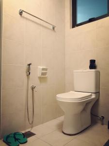 a bathroom with a toilet and a shower at Sara Staycation in Kajang