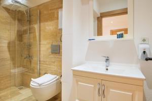 a bathroom with a toilet and a sink and a shower at MARE MARIN BOUTIQUE HOTEL in Bodrum City +52 photos