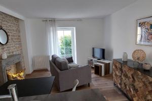a living room with a couch and a fireplace at Gîte chez Marianne- la halte Jurassienne in Montmorot