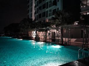 an empty swimming pool at night with lights at Sara Staycation in Kajang +12 photos