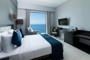 a hotel room with a bed and a view of the ocean at MaRadha Colombo in Colombo