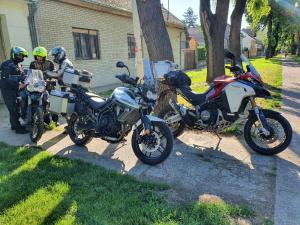 two motorcycles parked on a sidewalk next to a house at Citadela in Sombor