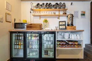 a refrigerator filled with lots of food and drinks at Alps Hostel in Pfronten