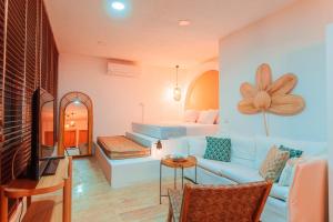a living room with a couch and a bed at MARE MARIN BOUTIQUE HOTEL in Bodrum City