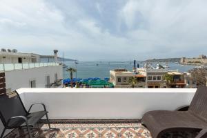 a balcony with two chairs and a view of the ocean at Akkan Hotel in Bodrum City