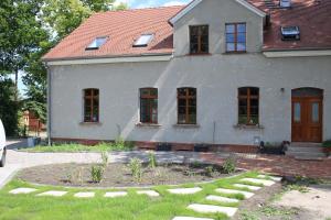 a house with a garden in front of it at Ferienwohnung Am Weltnaturerbe Grumsin in Ziethen +20 photos