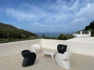 a group of chairs and a table on a roof at HMO Glamping & Suites in Vignanotica in Mattinata