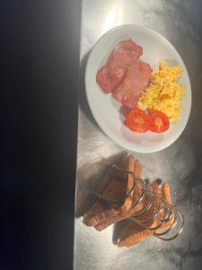 a plate of breakfast food with bacon eggs and toast at Osborne Hotel in Newcastle upon Tyne
