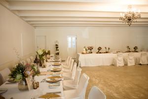 a large room with white tables and white chairs at Swartberg Hotel, Cork Tree Collection in Prince Albert +54 photos