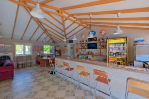 a room with a bar with orange chairs in it at Casablanca Hotel in Dalyan