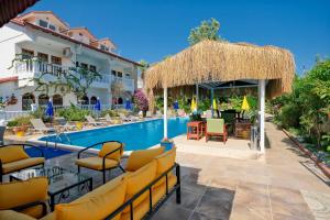 a resort with a pool and chairs and a building at Casablanca Hotel in Dalyan