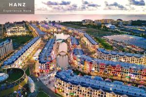 an aerial view of a city with a river and buildings at HANZ Teddy Sunset Grand World in Phu Quoc