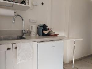 a kitchen with a sink and a counter top at Legatia in Jerusalem