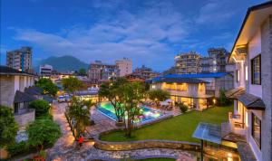 an aerial view of a city at night with a swimming pool at Hotel Barahi Pokhara in Pokhara