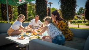 a group of people sitting around a table eating food at EuroParcs De Achterhoek in Lochem