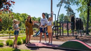 a group of people standing on a skateboard in a park at EuroParcs De Achterhoek in Lochem