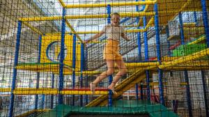 a woman is standing on a play structure at EuroParcs De Achterhoek in Lochem +4 photos