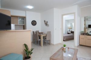a living room with a kitchen and a dining room at Anemone City Center Apartment in Heraklio