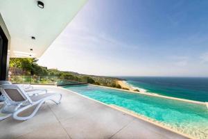 a swimming pool with a view of the ocean at Villa El Buzo in Zahara de los Atunes