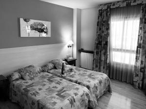 Postel nebo postele na pokoji v ubytování Hotel BONCOMPTE