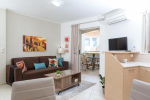 a living room with a couch and a table at Anemone City Center Apartment in Heraklio