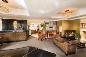 a woman in a living room with a pool table at The Popinjay Hotel in Larkhall