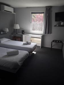Postel nebo postele na pokoji v ubytování Contact Hôtel ALYS Bourg en Bresse Ekinox Parc Expo