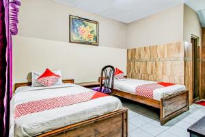Katil atau katil-katil dalam bilik di OYO 91053 Desa Wisata Gilimanuk
