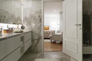 a kitchen with a door leading to a bedroom at Lisbon Rentals Chiado in Lisbon +178 photos