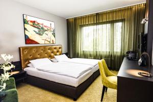 Säng eller sängar i ett rum på Hotel Der Blaue Reiter