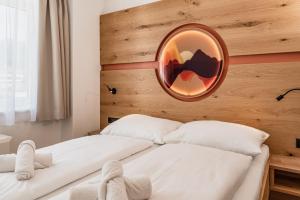 two beds in a room with a mirror on the wall at ''die Bergerin'' | Appartements Schladming in Schladming